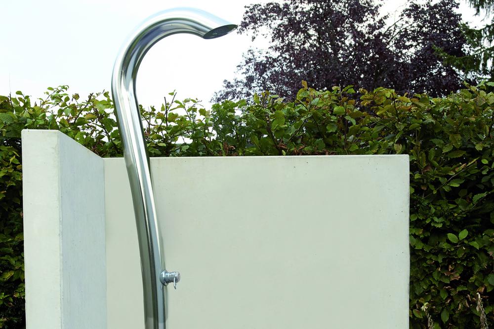 [Translate to Polski:] Eckwand aus Beton hinter einer Dusche in einem Freibad